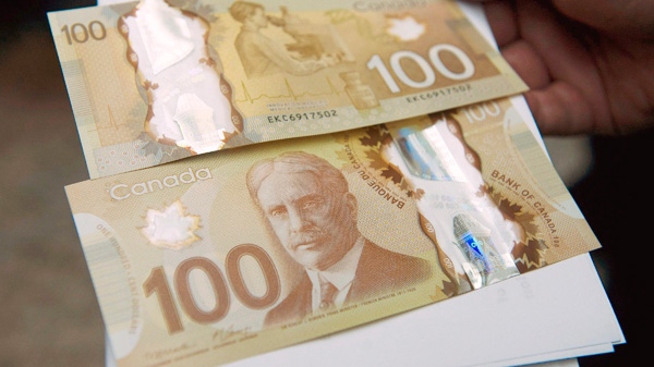 The Bank of Canada's new circulating $100 bill, Canada's first polymer bank note, is shown in Toronto on Monday Nov. 14, 2011. (Nathan Denette / THE CANADIAN PRESS)