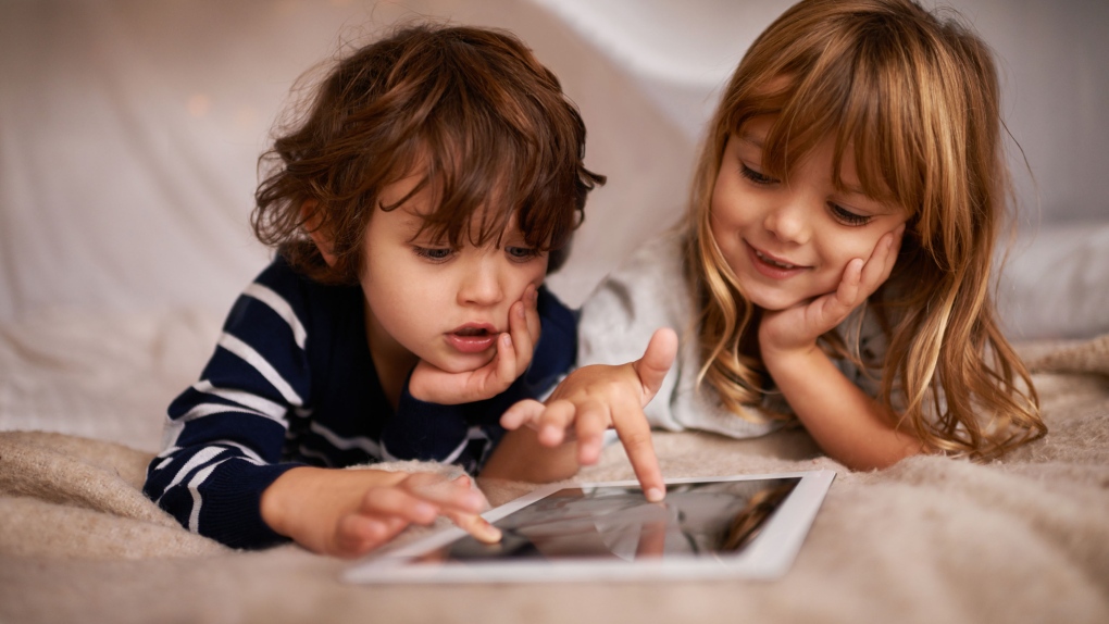 A new study advises limits on screen time for children and teenagers to help boost their well-being.(PeopleImages / IStock.com)