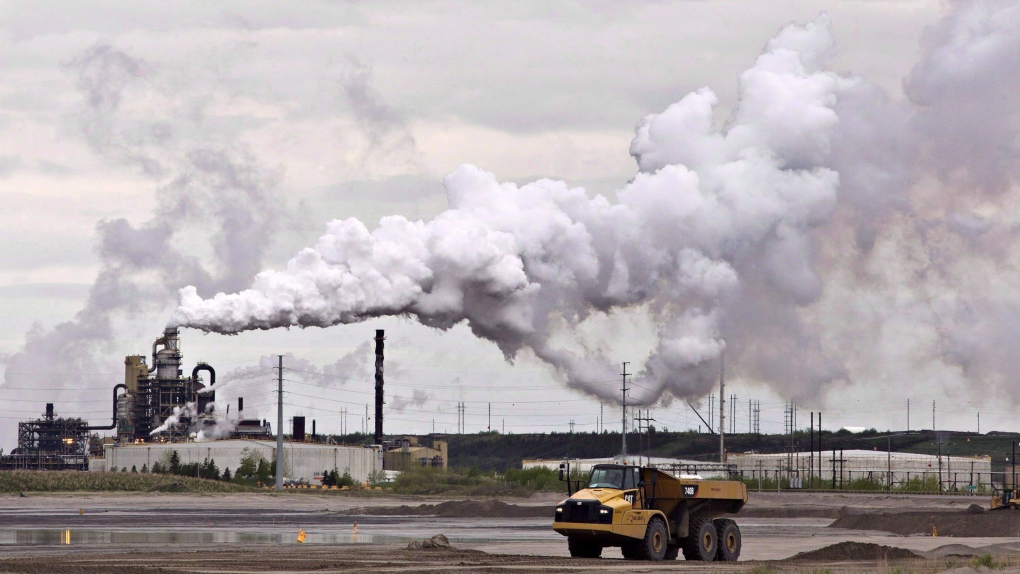 A dump truck works by an oilsands extraction facility near the city of Fort McMurray, Alberta on Sunday June 1, 2014. (THE CANADIAN PRESS/Jason Franson)