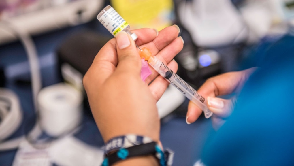 A health care worker fills a needle with the drug Gardasil, used for HPV vaccinations. (Getty Images)