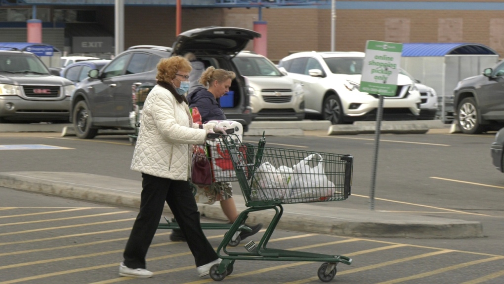Shoppers walk through the parking lot of a Save on Foods location in Lethbridge. 
