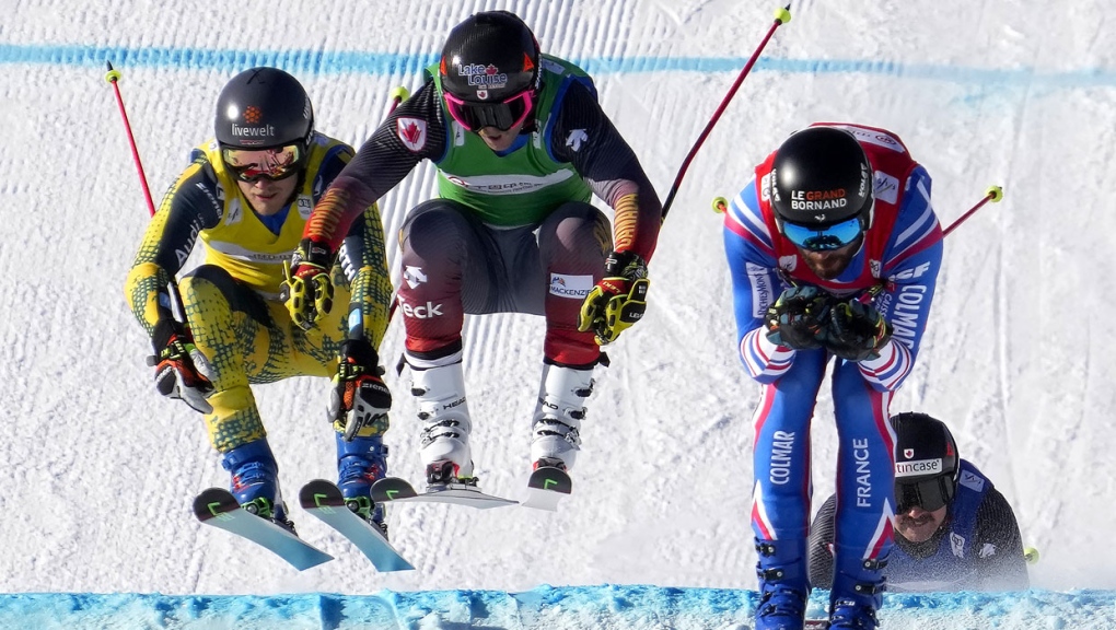 From left, Tim Hronek of Germany, Brady Leman of Canada, and Bastien Midol of France compete during the quarterfinal round in men's ski cross during the FIS Ski Cross World Cup, a test event for the 2022 Winter Olympics, at the Genting Resort Secret Garden in Zhangjiakou in northern China's Hebei Province, Saturday, Nov. 27, 2021. (AP Photo/Mark Schiefelbein)