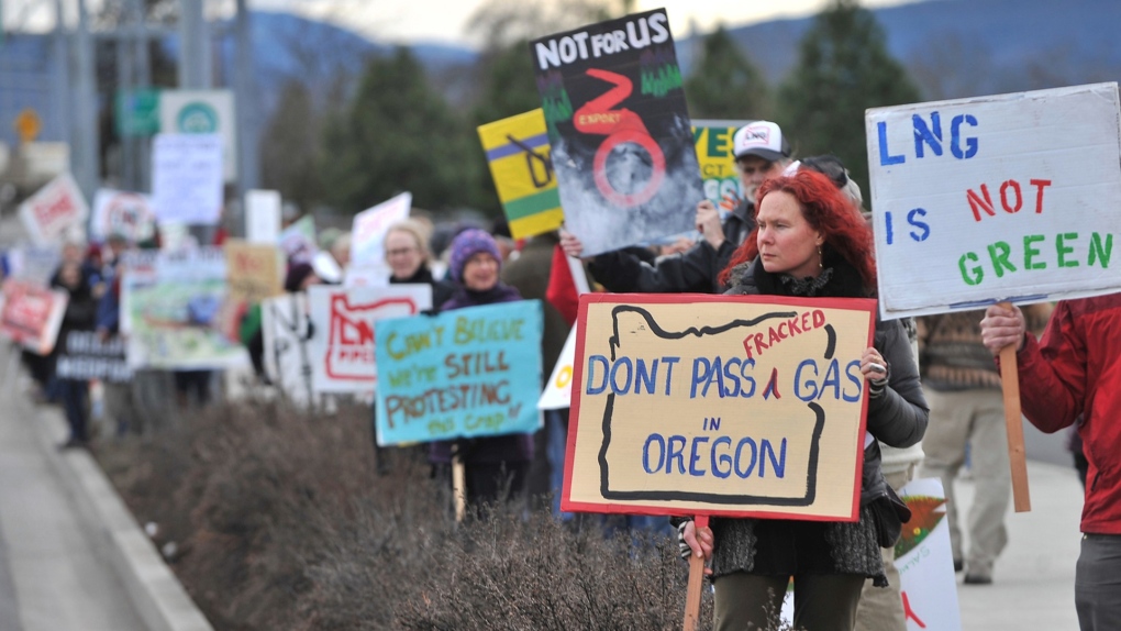 People protest against the Jordan Cove LNG Pipeline on Crater Lake Highway in Medford, Ore., on Jan. 6, 2016. The company that sought to build the natural gas pipeline and marine export terminal in Oregon pulled the plug on the controversial project Wednesday, Dec. 1, 2021, after failing to obtain all necessary state permits. (Jamie Lusch/The Medford Mail Tribune via AP, File)
