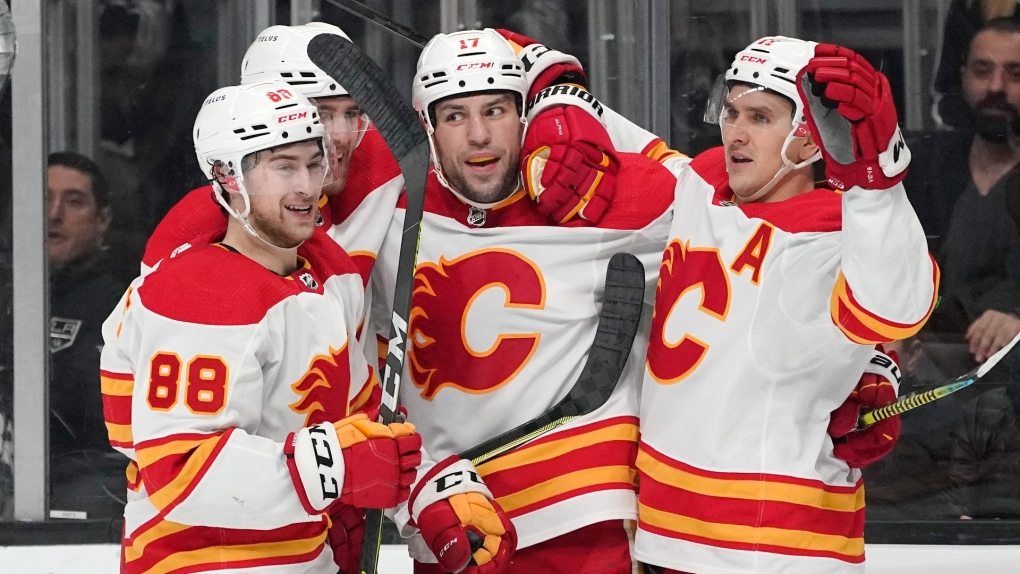 Calgary Flames left wing Milan Lucic, second from right, celebrates his goal with teammates left wing Andrew Mangiapane, left, defenseman Noah Hanifin, second from left, and center Mikael Backlund during the first period of an NHL game against the Los Angeles Kings on Dec. 2, 2021, in Los Angeles. (AP Photo/Mark J. Terrill)