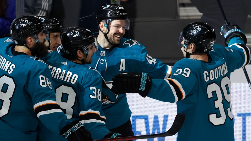 San Jose Sharks center Tomas Hertl, second from right, celebrates his goal against the Calgary Flames with defenseman Brent Burns (88), defenseman Mario Ferraro (38) and center Logan Couture, right, during the third period of an NHL game Dec. 7,  in San Jose, Calif. (AP Photo/Josie Lepe)