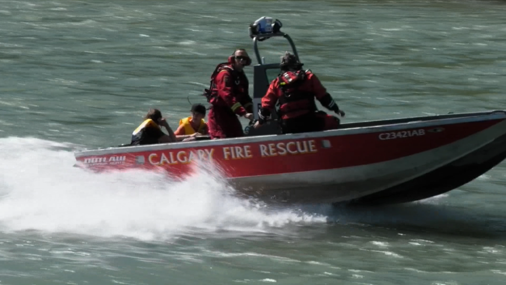 The Calgary Fire Department aquatics rescue team brings two rafters back to shore after their raft capsized Thursday morning. A second trip was made to retrieve the third member of the rafting group.