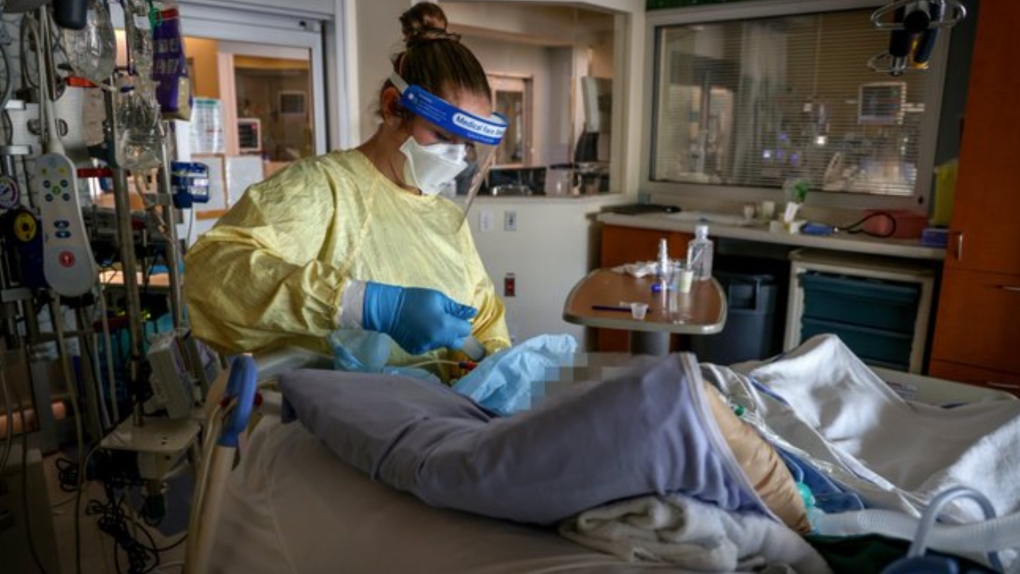 A registered nurse works with a COVID-19 patient on the Intensive Care Unit at Foothills Medical Centre on Sept. 10, 2021. (Alberta Health Services)