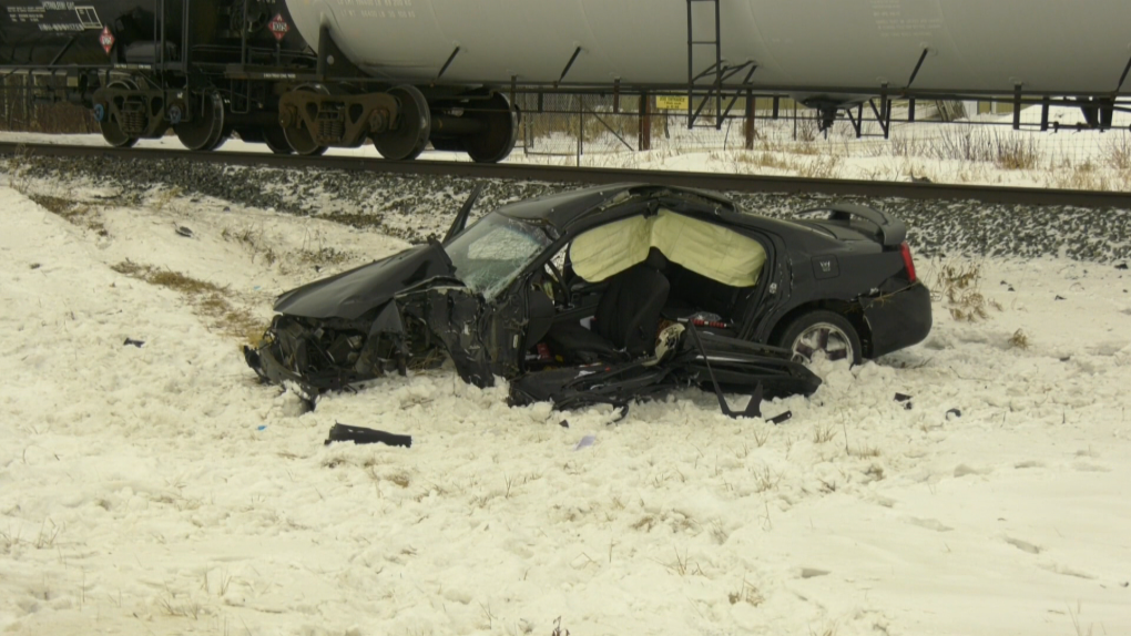 A damaged car next to a train at 35444 Highway 2A, north of Innisfail, following a Jan. 10 collision that sent a man to hospital in critical condition. 