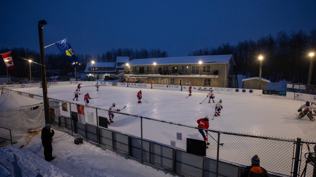 Players take part in the World's Longest Hockey Game near Edmonton on Thursday, Feb. 11, 2021. It's a game of chance for thousands of Albertans playing group sports as the Omicron COVID-19 variant of concerns rips through the province. (THE CANADIAN PRESS/Jason Franson)