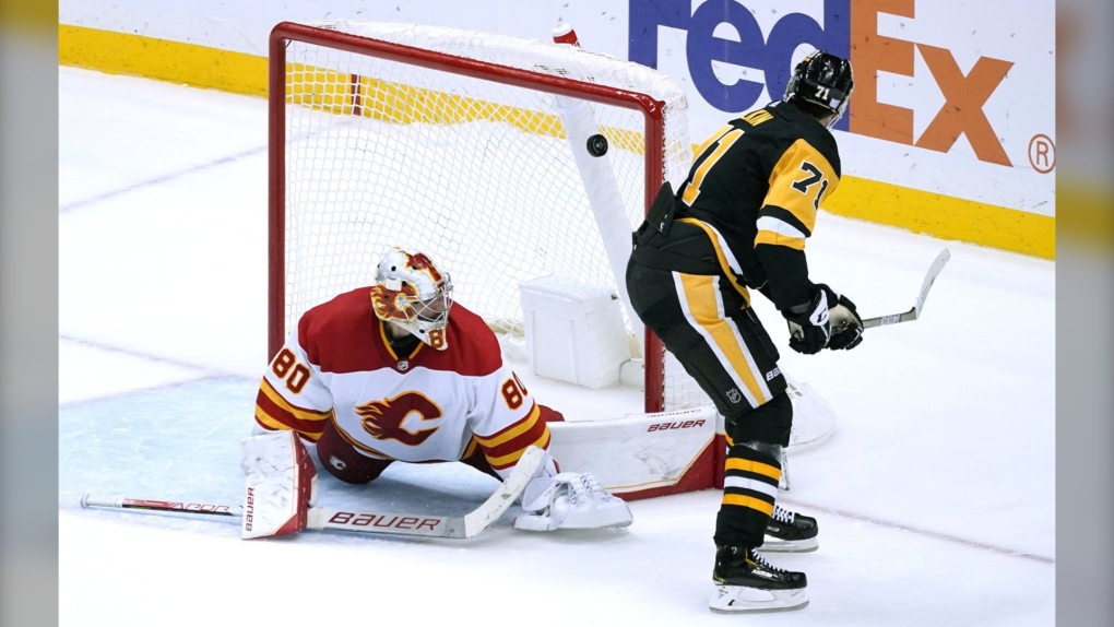 The Pittsburgh Penguins' Evgeni Malkin gets a backhand shot past Calgary Flames goaltender Dan Vladar for a shootout goal in Pittsburgh on Nov. 23, 2022. (AP Photo/Gene J. Puskar)