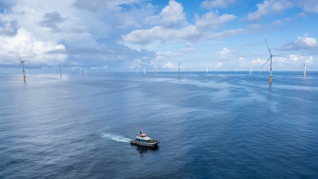A boat passes as France's first commercial-scale offshore wind farm, Saint-Nazaire, is seen in an undated handout photo. Enbridge and its partners EDF Renewables and CPP Investments announced the completion of the wind farm Wednesday. (THE CANADIAN PRESS/HO-Enbridge, Christophe Beyssier,)