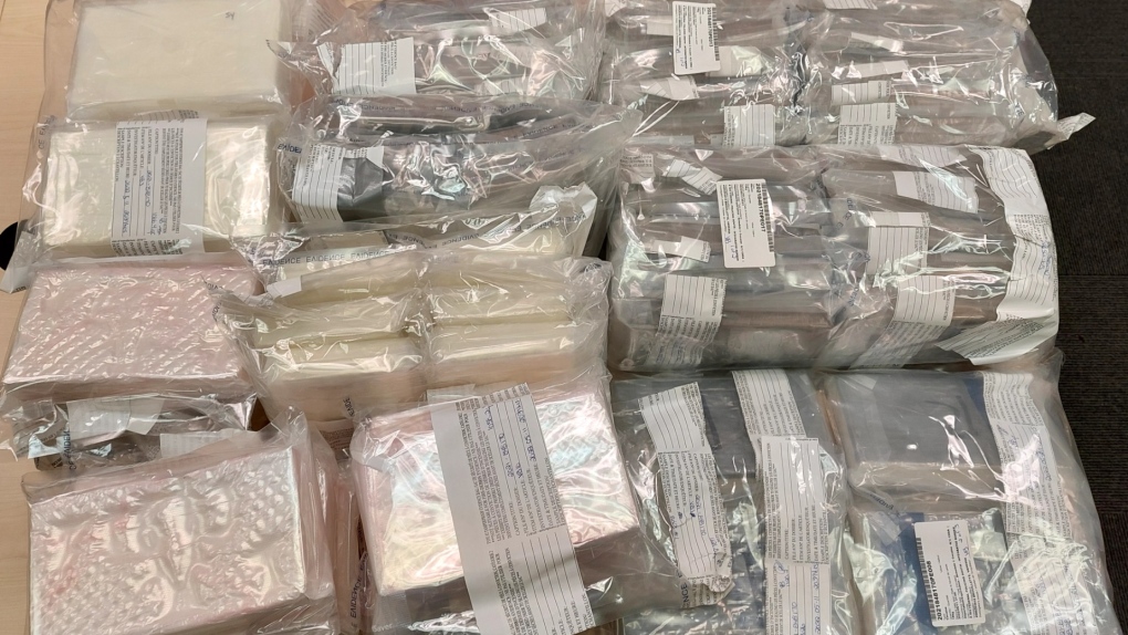 Bundles of heroin and cocaine seized during the investigation into an Edmonton man's alleged smuggling of drugs into Canada in transport trucks. (image: Integrated Border Enforcement Team)