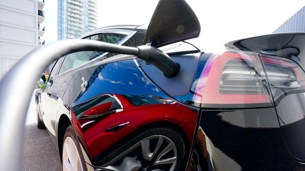 An electric vehicle is charged in Ottawa on Wednesday, July 13, 2022. Parkland Corp. says it is doubling the size of its previously announced electric vehicle charging network in western Canada.THE CANADIAN PRESS/Sean Kilpatrick