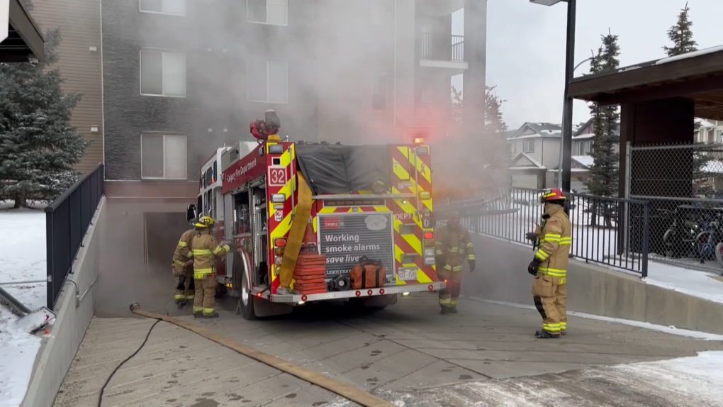 A CFD engine and crew shrouded in steam during a car fire response in the parking garage of a condo building in Saddle Ridge.