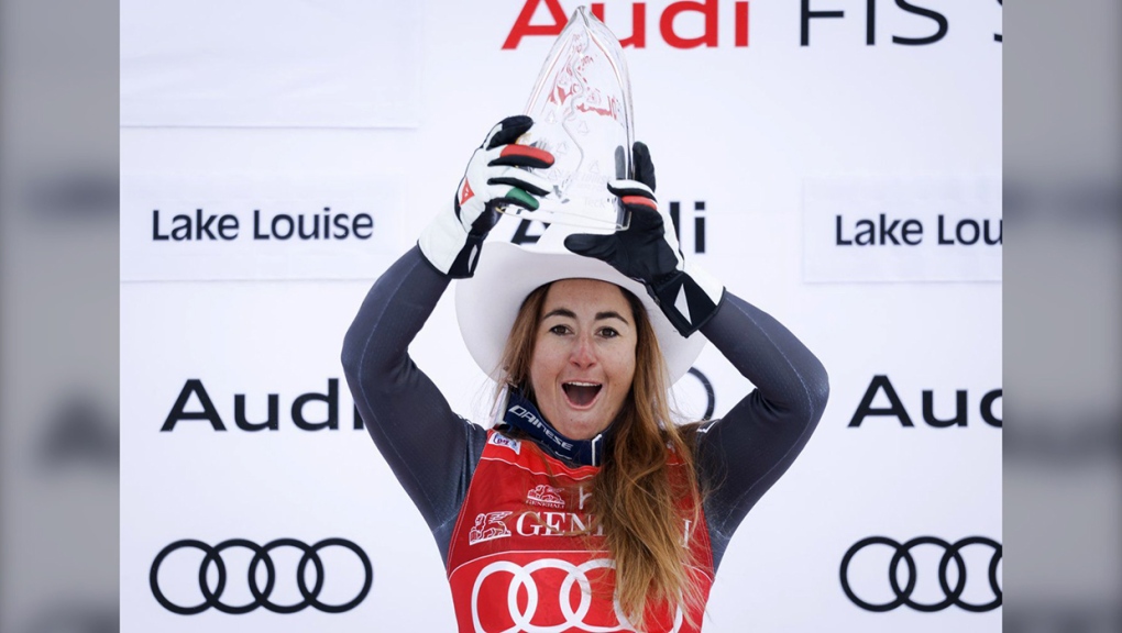 Italy's Sofia Goggia celebrates her victory on the podium following the women's downhill race at the FIS Alpine Skiing World Cup, in Lake Louise, Alta., Friday, Dec. 2, 2022. THE CANADIAN PRESS/Jeff McIntosh