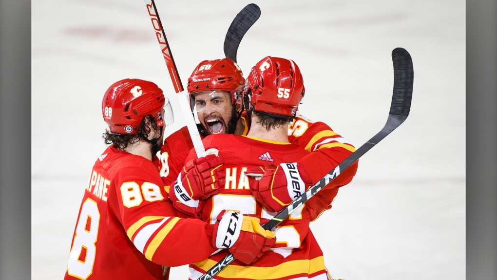 Calgary Flames' Oliver Kylington, centre, celebrates his goal with teammates during second period NHL hockey action against the Toronto Maple Leafs in Calgary, Thursday, Feb. 10, 2022.(THE CANADIAN PRESS/Jeff McIntosh)
