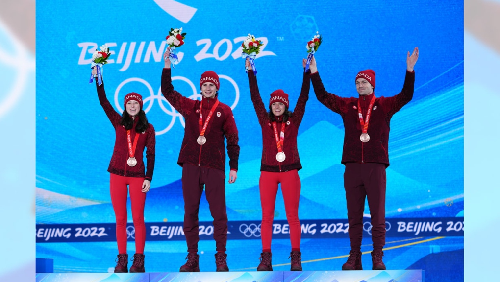 Canada's bronze medallists (left to right) Alexandria Loutitt, Matthew Soukup, Abigail Strate and Mackenzie Boyd-Clowes, celebrate during the medal ceremony for mixed team ski jumping at the Beijing Winter Olympics in Zhangjiakou, China, on Tuesday, Feb. 8, 2022. THE CANADIAN PRESS/Sean Kilpatrick
