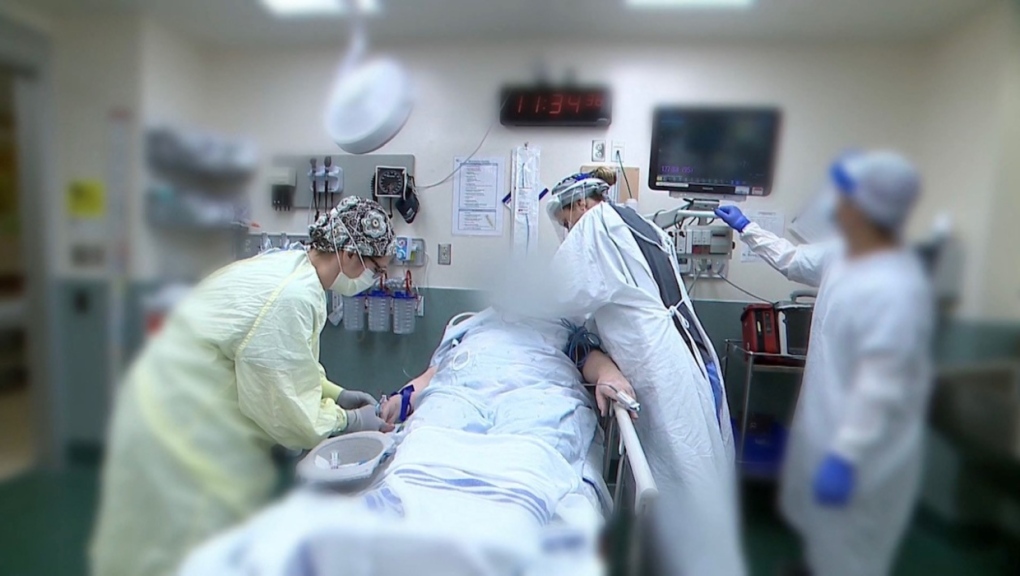 Health-care workers perform life-saving surgery on a patient.  