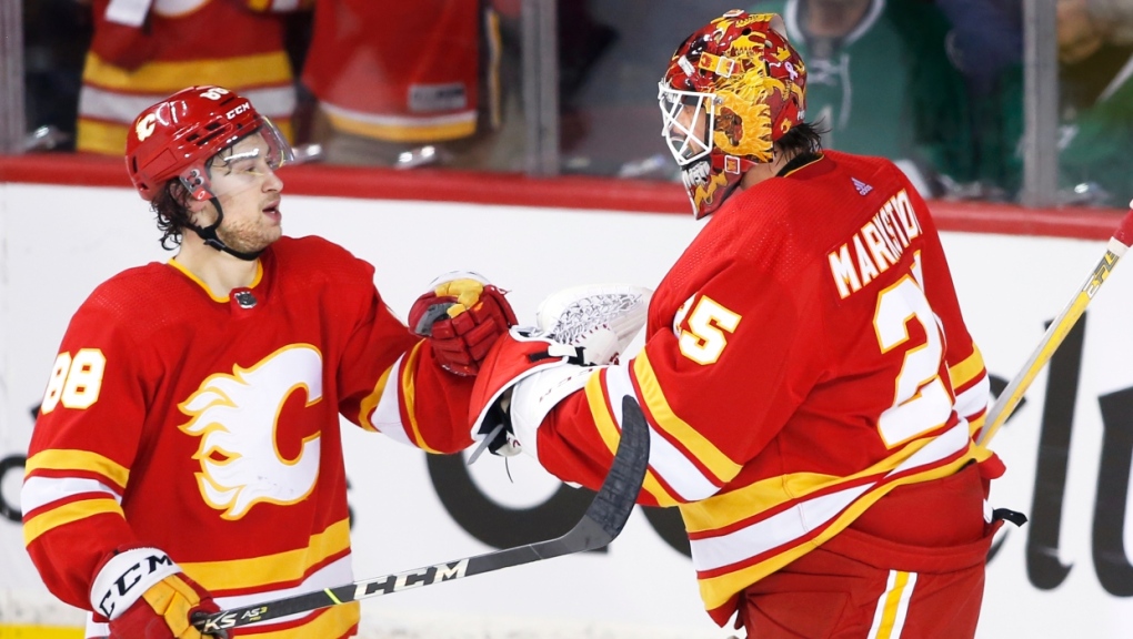 Calgary Flames left wing Andrew Mangiapane (88) and goaltender Jacob Markstrom (25) celebrate defeating the Dallas Star after NHL first-round playoff series action on Wednesday May 11, 2022. Mangiapane scored the game winning goal. (THE CANADIAN PRESS/Larry MacDougal)