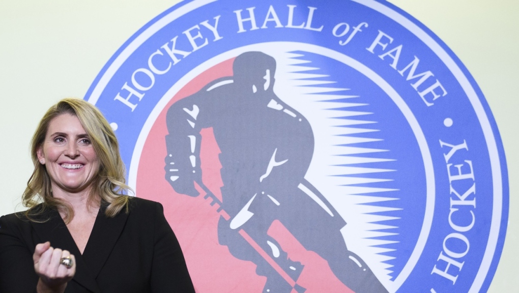 Hockey Hall of Fame inductee Hayley Wickenheiser shows off her ring on stage in Toronto on Friday, November 15, 2019. (THE CANADIAN PRESS/Nathan Denette)