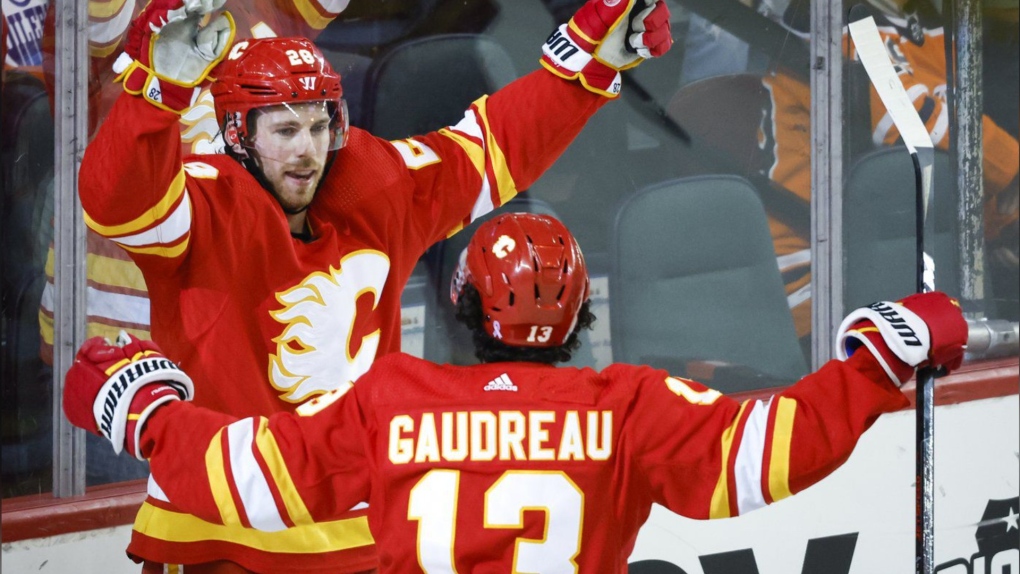 Calgary Flames' Elias Lindholm celebrates his goal with teammate Johnny Gaudreau during first period NHL hockey action against the Edmonton Oilers in Calgary, Saturday, March 26, 2022. Elias Lindholm is one of three finalists for the Frank J. Selke Trophy. (THE CANADIAN PRESS/Jeff McIntosh)