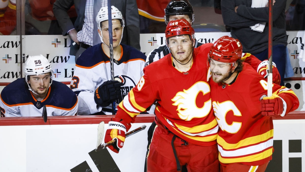 Edmonton Oilers players look on as Calgary Flames forward Matthew Tkachuk, left, celebrates his goal with teammate defenceman Rasmus Andersson during third period NHL second round playoff hockey action in Calgary, Wednesday, May 18, 2022.THE CANADIAN PRESS/Jeff McIntosh