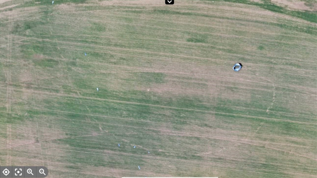 Drone image showing a large fragment of the destroyed grain bin that scoured the ground as it was moved in a loop around the tornado