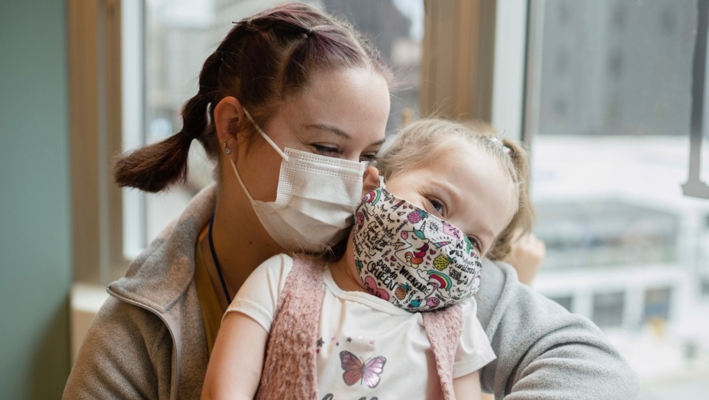 Delilah Edwards, 3, who recently underwent a heart transplant, and her mother, Samantha Davidson, embrace at Ronald McDonald House's playroom in Chicago. (Pat Nabong/Chicago Sun-Times via AP)