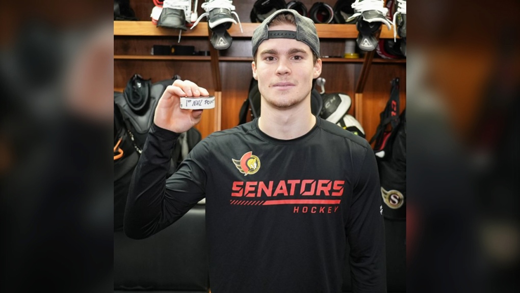 Lethbridge's Ridly Greig holds up the puck he used to get his first NHL point Wednesday night. Ottawa defeated the Islanders 2-1.