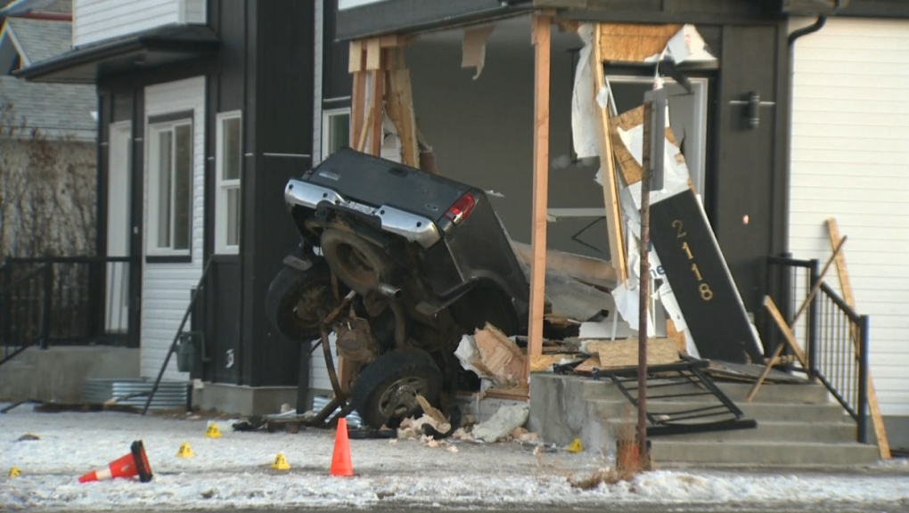 Calgary police investigate a collision in Ogden on Friday, Jan. 6, 2023 that saw a vehicle smash into a house. 