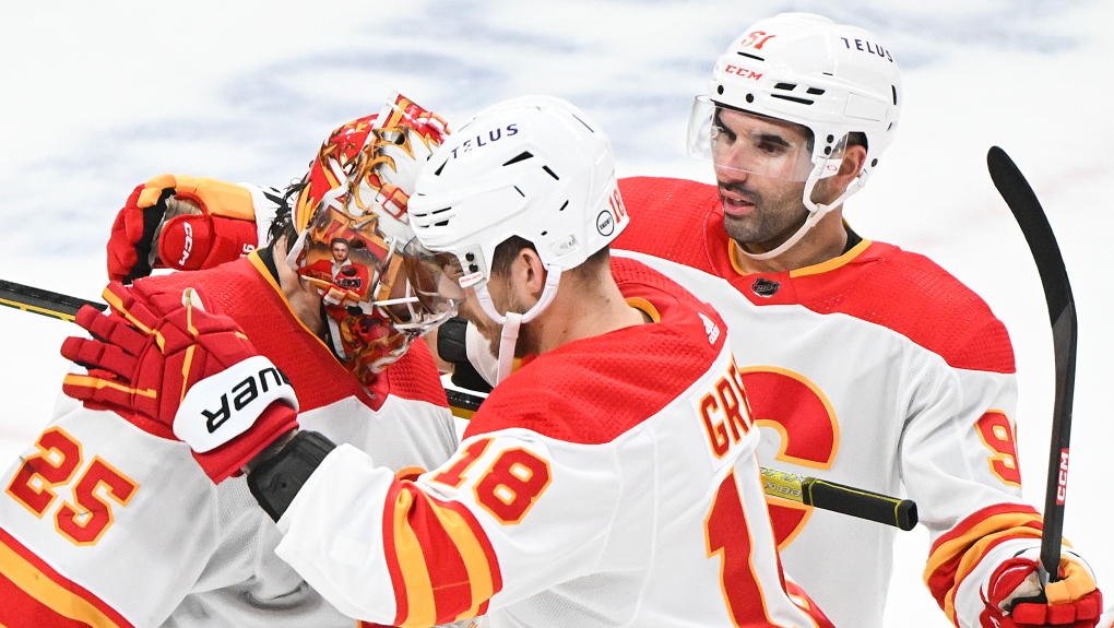 Calgary Flames goaltender Jacob Markstrom (25) celebrates with teammates Nazem Kadri (right) and A.J. Greer (18) after defeating the Montreal Canadiens in an NHL hockey game in Montreal, Tuesday, November 14, 2023. THE CANADIAN PRESS/Graham Hughes
