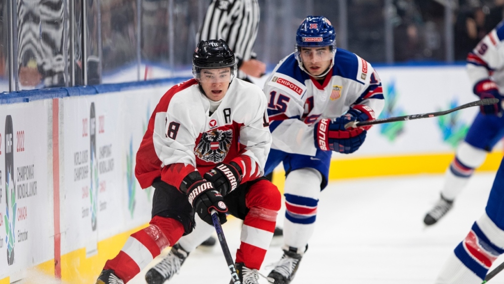 USA's Matthew Coronato (15) chases Austria's Martin Urbanek (18) during first period IIHF World Junior Hockey Championship action in Edmonton on Saturday August 13, 2022. (THE CANADIAN PRESS/Jason Franson)