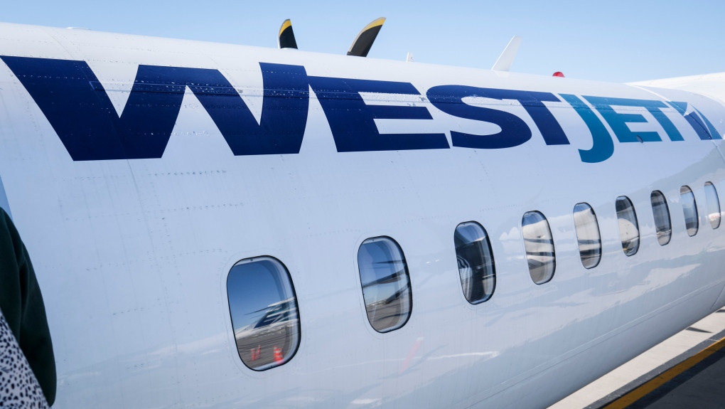 A WestJet plane waits at a gate at Calgary International Airport in Calgary, Alta., Wednesday, Aug. 31, 2022.THE CANADIAN PRESS/Jeff McIntosh