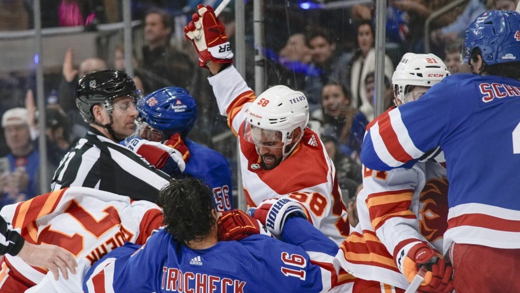 Players fight during an NHL hockey game between the New York Rangers and the Calgary Flames on Feb. 12, 2024, in New York. (AP Photo/Bryan Woolston)